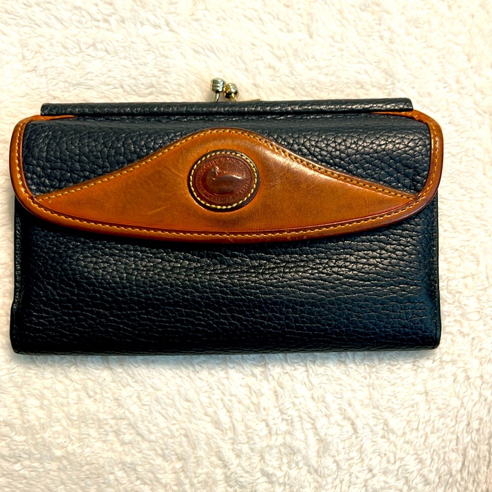 Dooney & Bourke vintage leather wallet in navy with camel colored trim.
